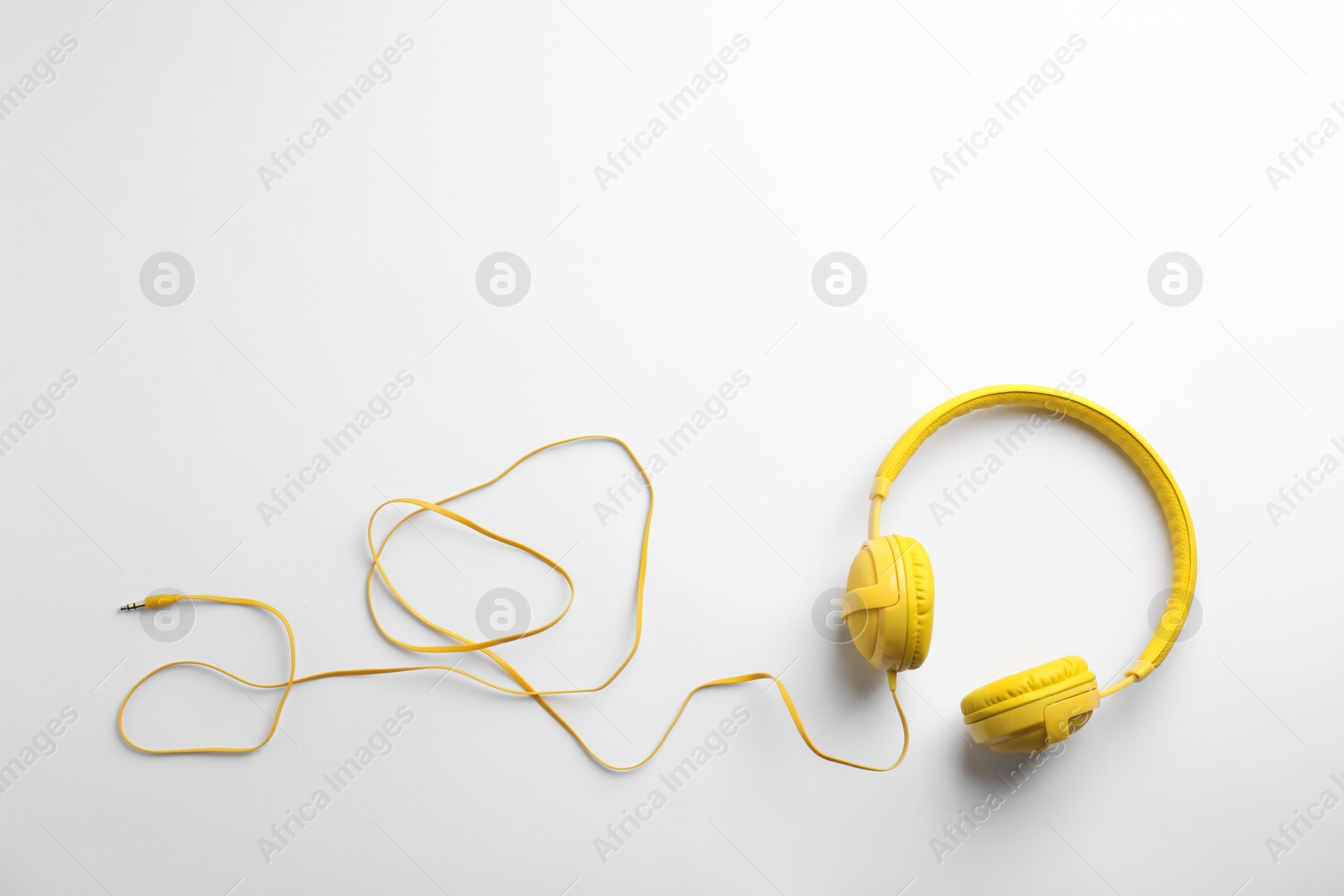 Photo of Stylish modern headphones with earmuffs on white background, top view. Space for text