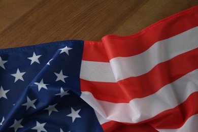 Photo of Flag of USA on wooden table, top view