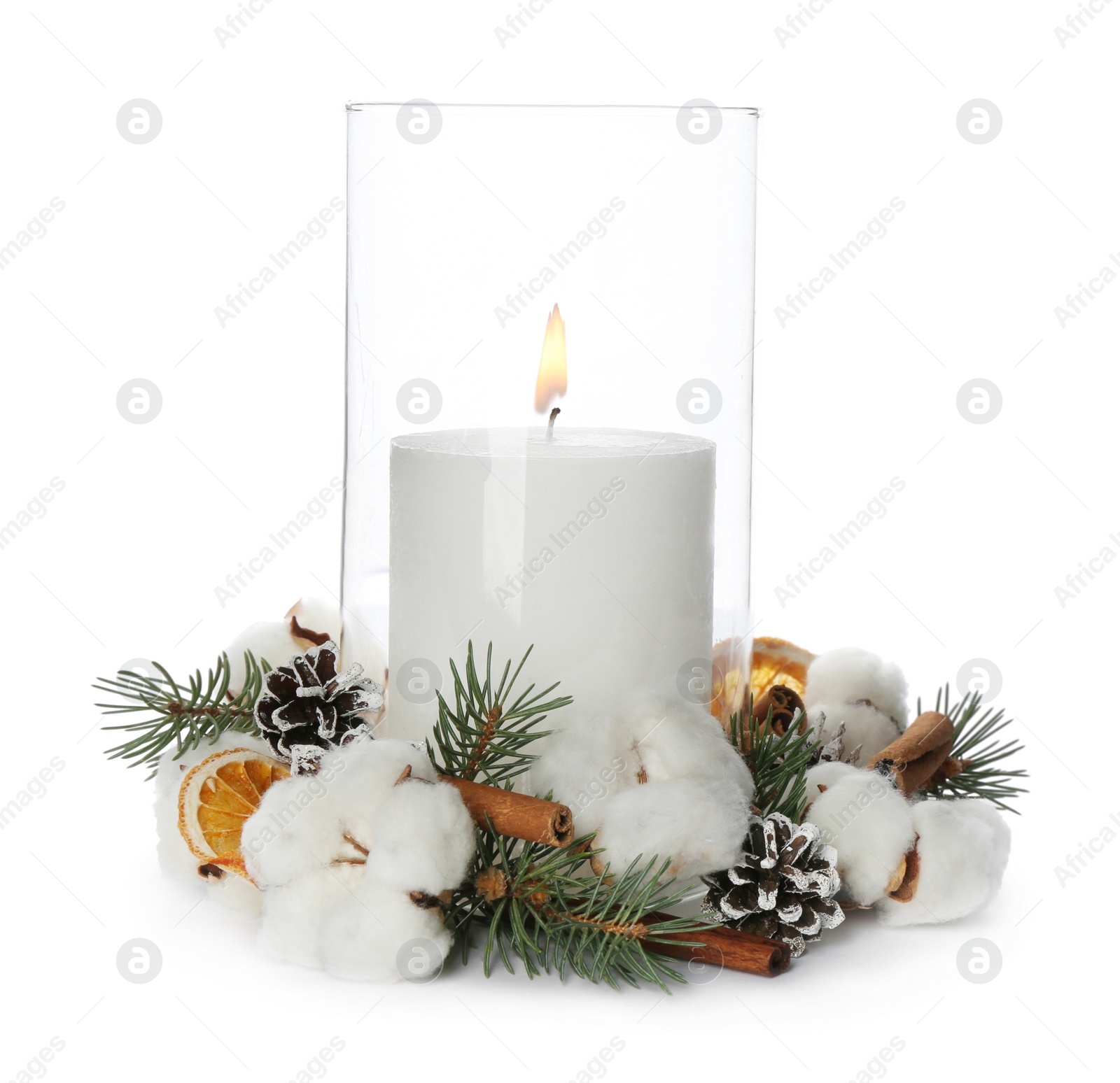 Photo of Glass holder with burning candle and Christmas decor isolated on white