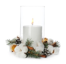 Photo of Glass holder with burning candle and Christmas decor isolated on white