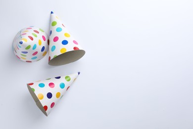 Photo of Colorful party hats on light background, top view. Space for text