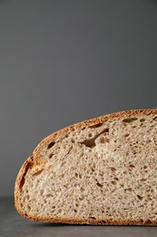 Photo of Piece of freshly baked sourdough bread on grey table