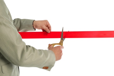 Photo of Man in office suit cutting red ribbon isolated on white, closeup