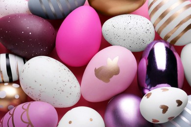 Photo of Beautifully painted Easter eggs as background, top view