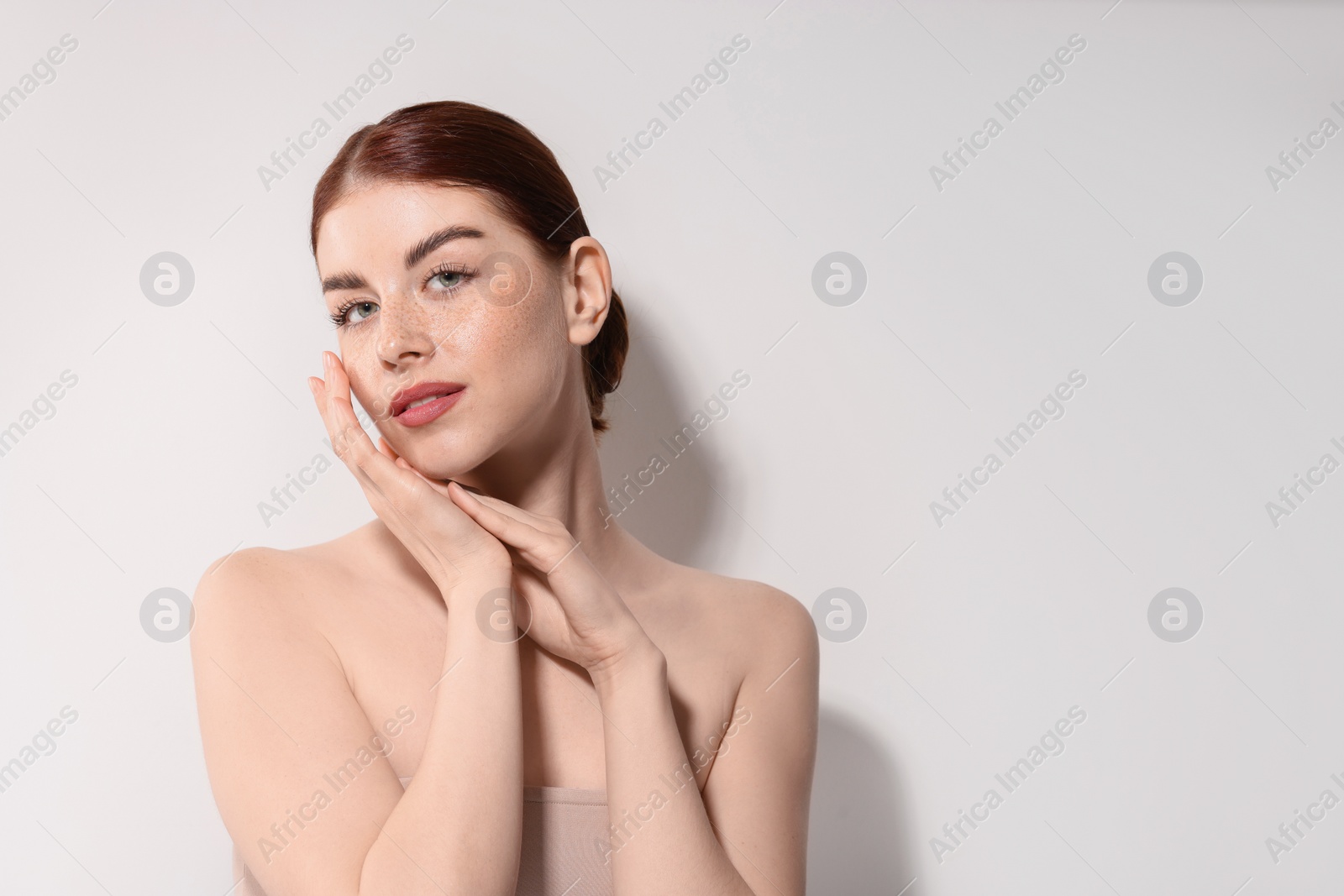 Photo of Portrait of beautiful woman on light background. Space for text