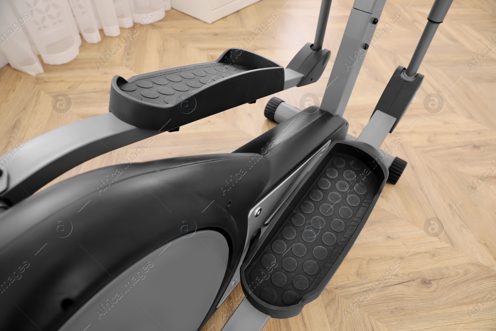 Photo of Modern elliptical machine cross trainer indoors, closeup