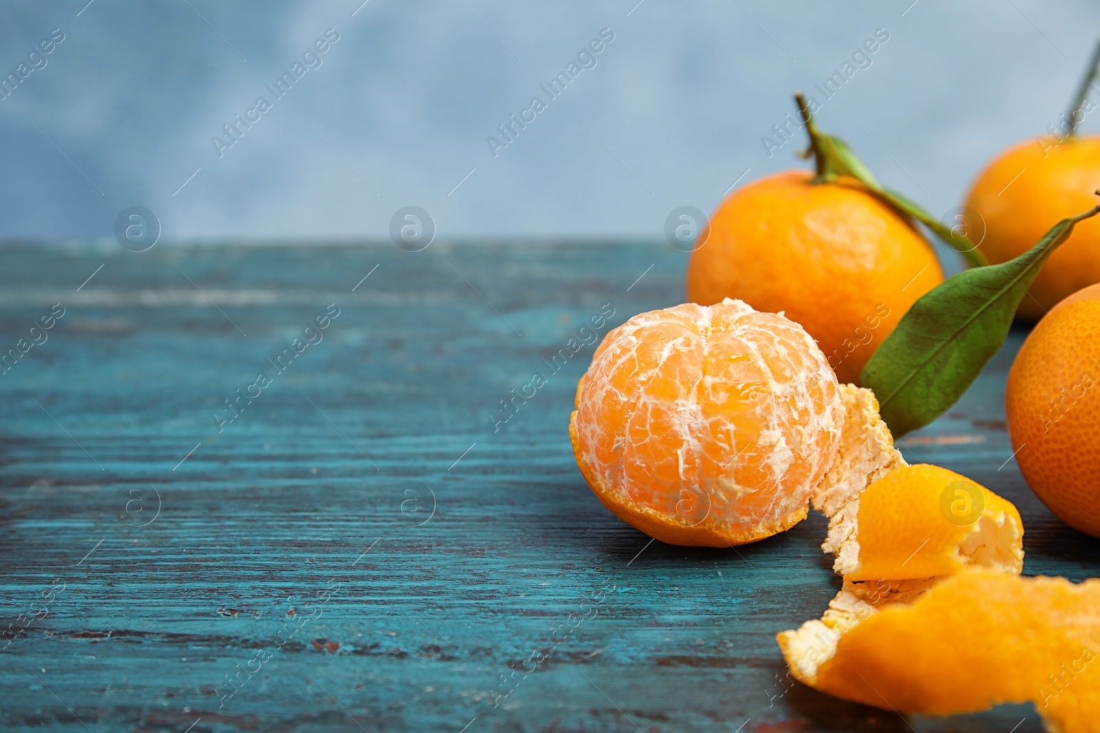 Photo of Fresh ripe tangerines on table. Space for text