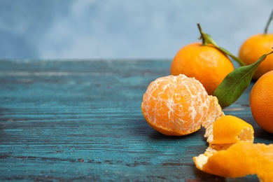 Photo of Fresh ripe tangerines on table. Space for text