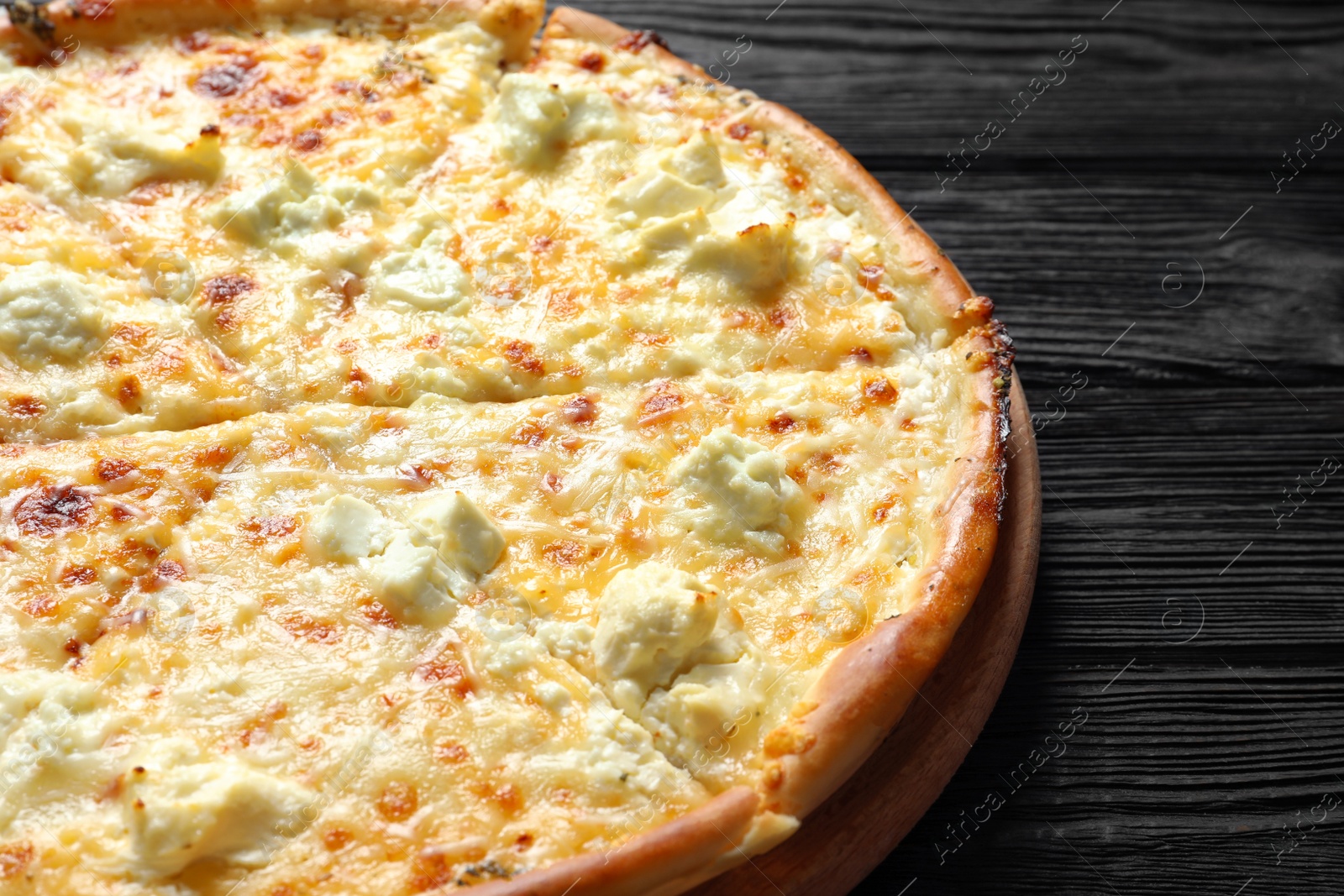 Photo of Tasty hot cheese pizza on wooden background