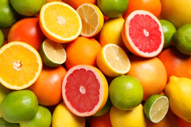 Photo of Different fresh citrus fruits as background, top view