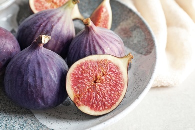 Photo of Plate with fresh ripe figs on table, closeup