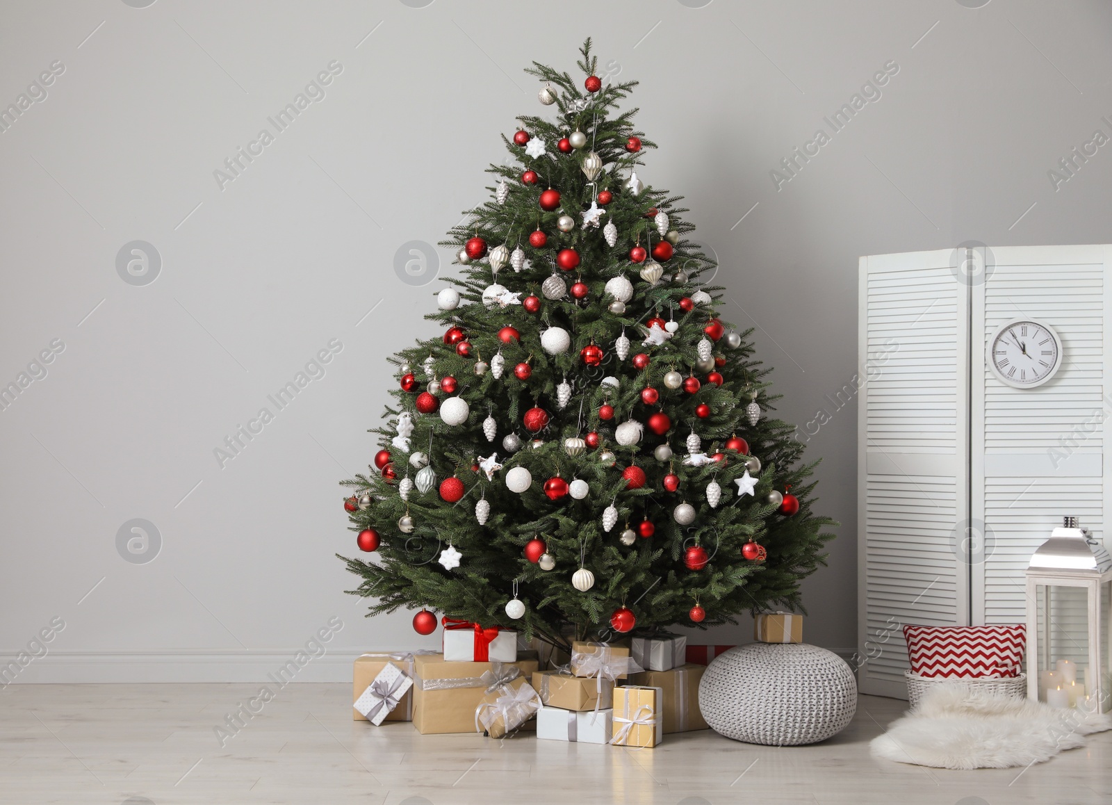 Photo of Beautifully decorated Christmas tree and many gift boxes in room, space for text