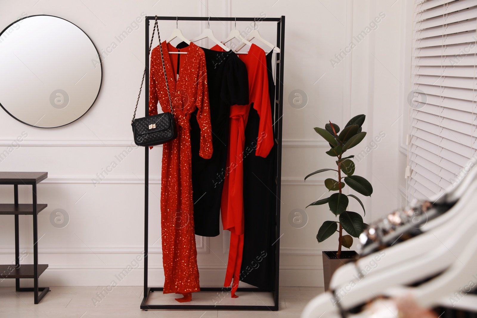 Photo of Collection of trendy women's garments in clothing rental salon