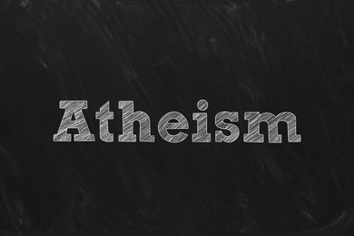 Illustration of Word Atheism written on black chalkboard. Philosophical or religious position