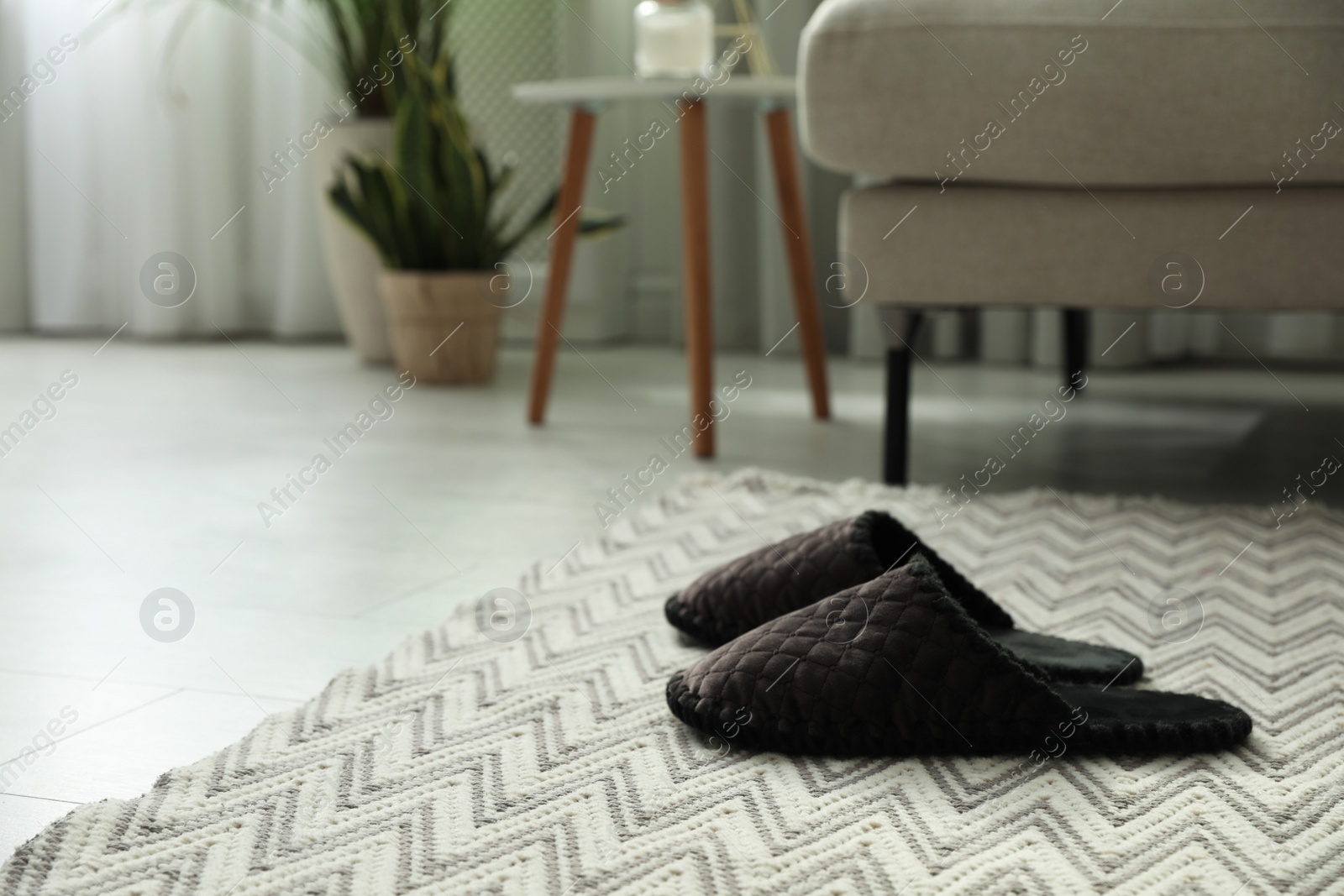 Photo of Soft slippers on carpet in living room