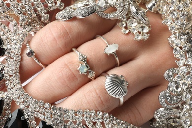 Woman with elegant rings on fingers, top view. Luxury jewelry