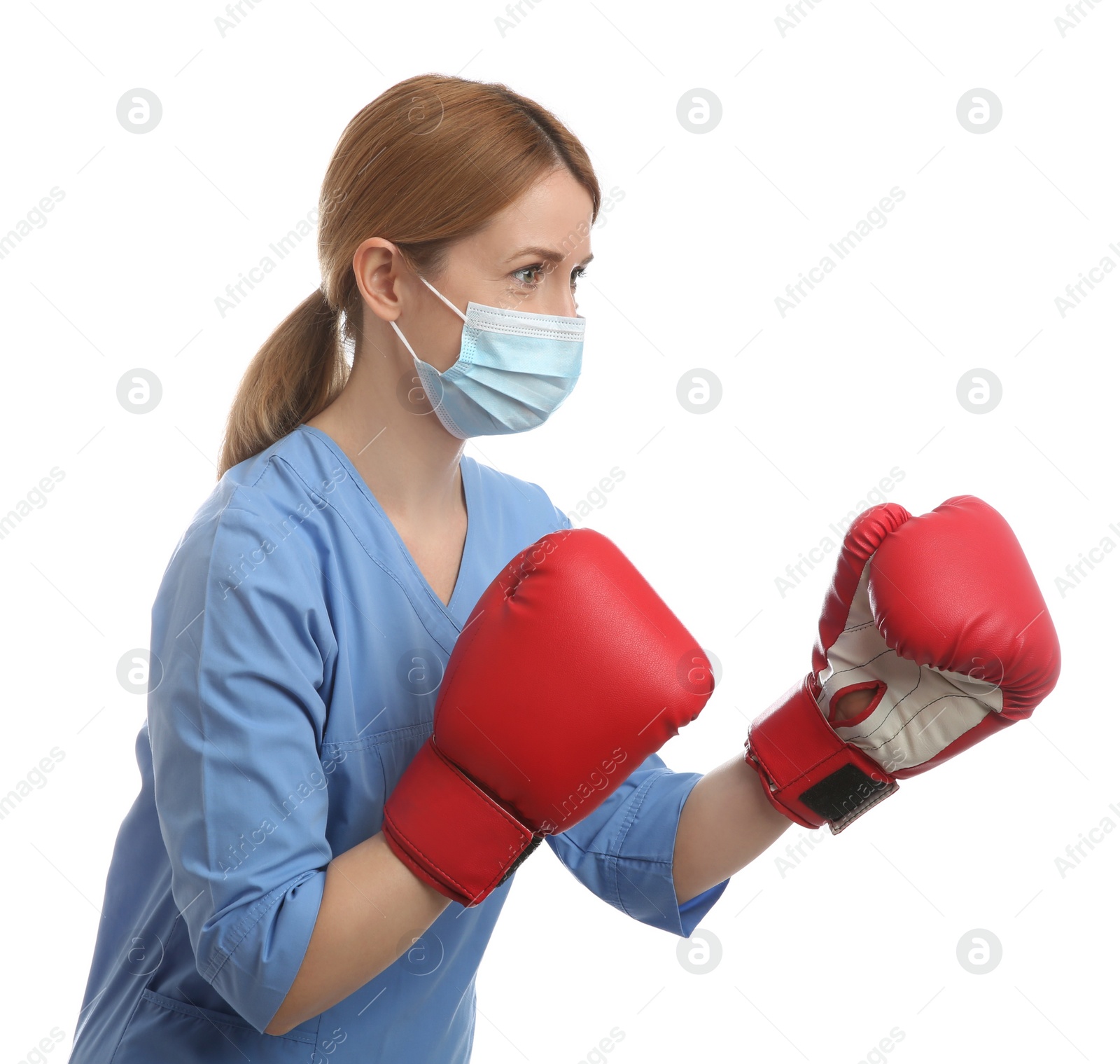 Photo of Doctor with protective mask and boxing gloves on white background. Strong immunity concept