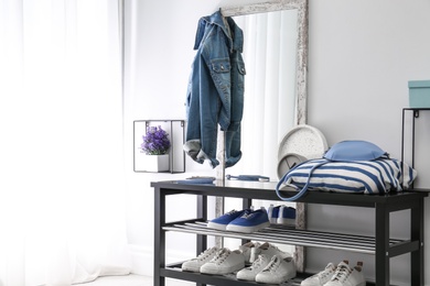 Photo of Cozy stylish hallway interior with shoe rack and mirror. Home design idea