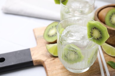 Photo of Refreshing drink with kiwi on table, closeup. Space for text