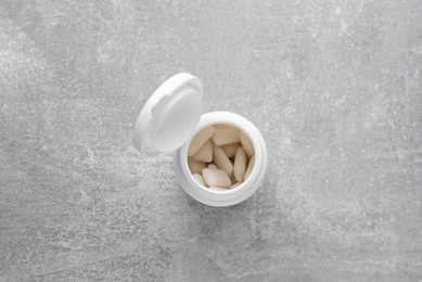 Jar with chewing gums on light grey table