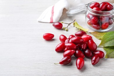 Pile of fresh ripe dogwood berries on white wooden table. Space for text