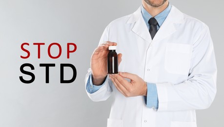 STOP STD. Doctor with medicament on light grey background, closeup