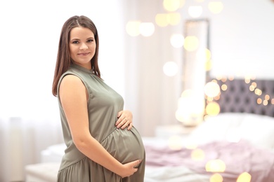 Beautiful pregnant woman at home