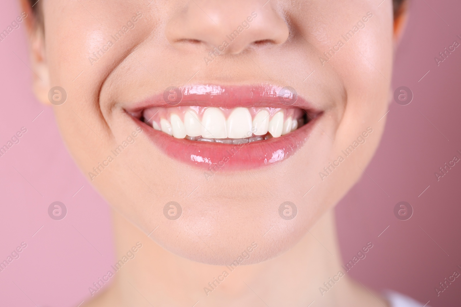 Photo of Young woman with healthy teeth and beautiful smile on color background, closeup