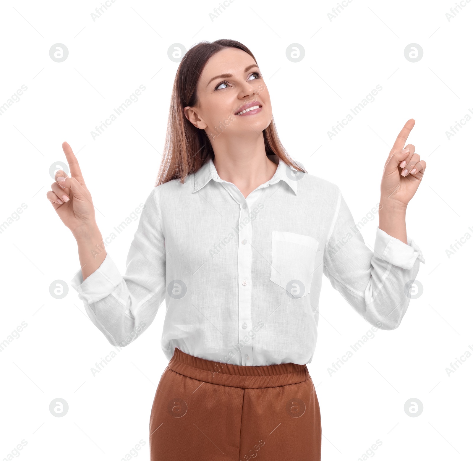 Photo of Beautiful happy businesswoman pointing at something on white background