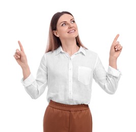 Photo of Beautiful happy businesswoman pointing at something on white background