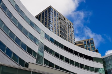 Photo of Exterior of beautiful buildings against blue sky, low angle view