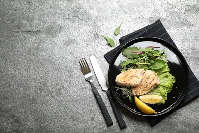 Photo of Tasty grilled fish on grey table, flat lay. Space for text
