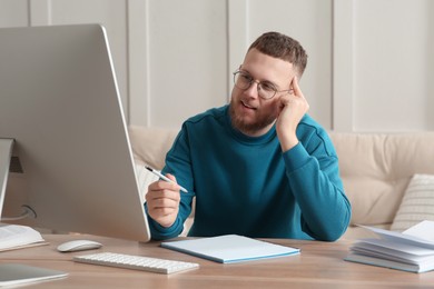 Online test. Man studying with computer at home
