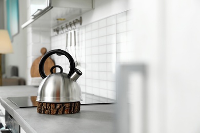 Photo of Modern kettle on kitchen counter indoors, space for text