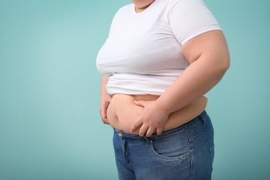 Photo of Overweight woman on color background