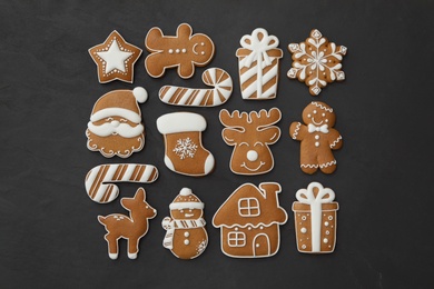 Photo of Many different delicious Christmas cookies on black table, flat lay