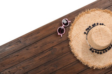 Photo of Flat lay composition with beach accessories on wooden background. Space for text