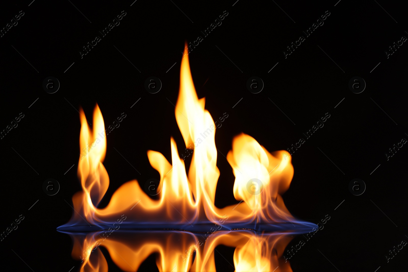 Photo of Beautiful view of flaming vodka on black background