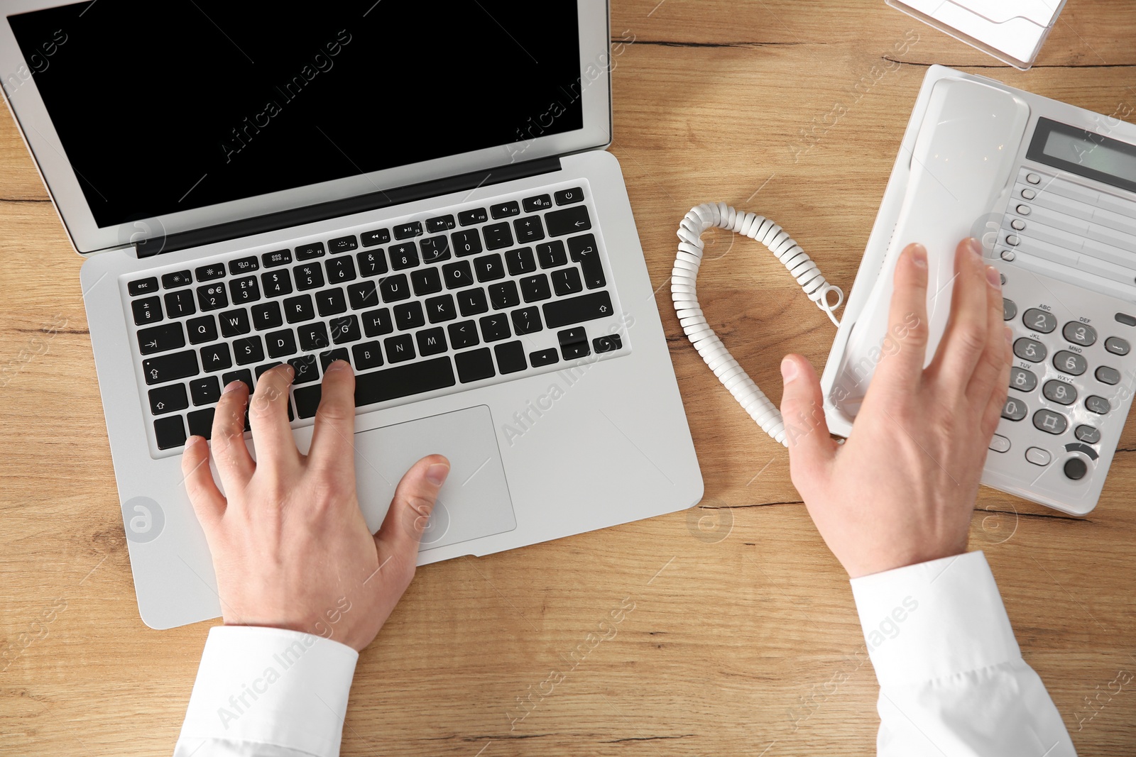Photo of Male technical support operator working in office, closeup of hands