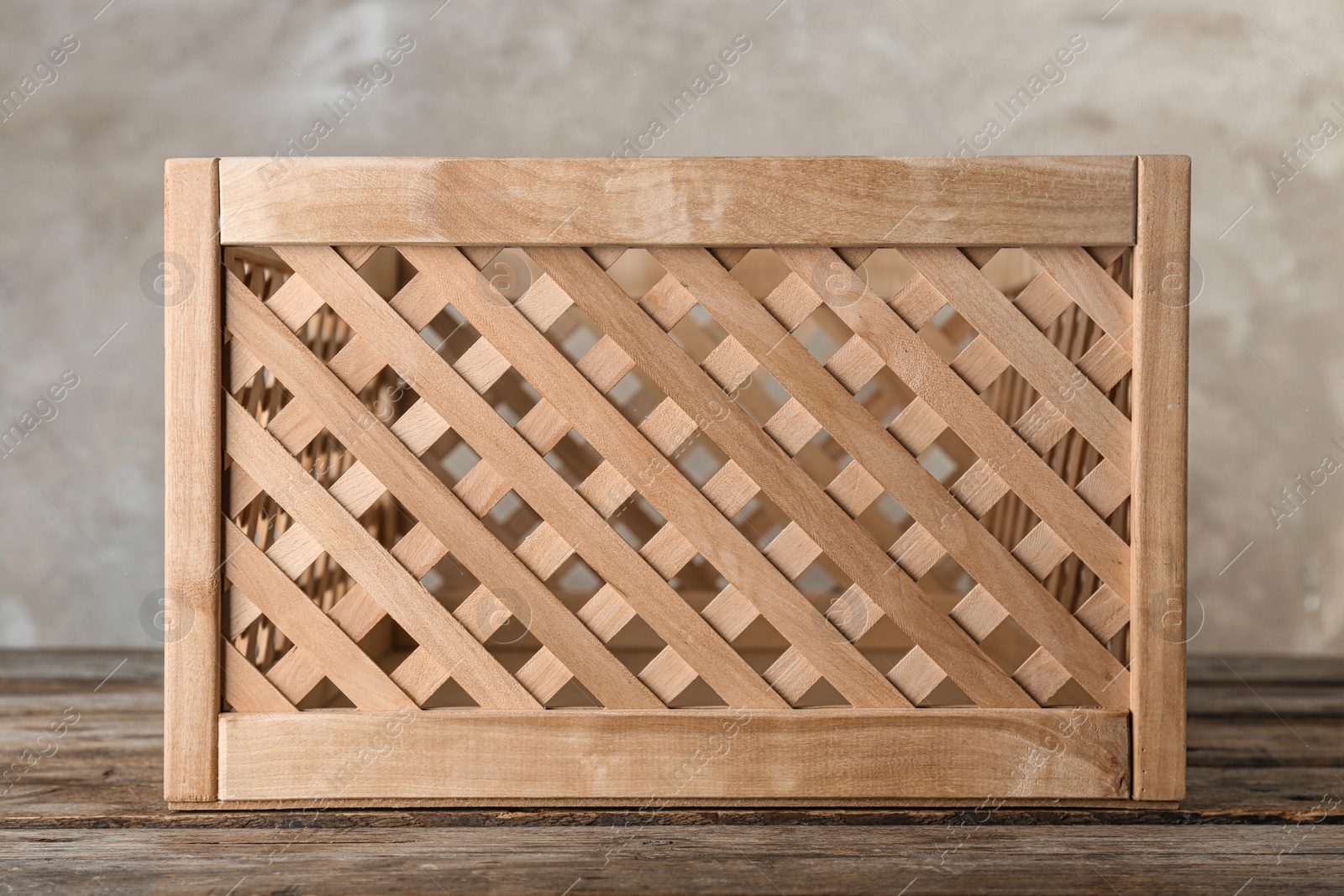 Photo of Wooden crate on table against color background