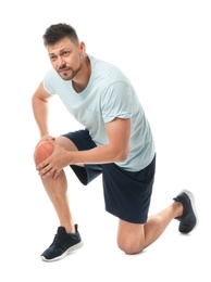 Photo of Full length portrait of sportsman having knee problems on white background