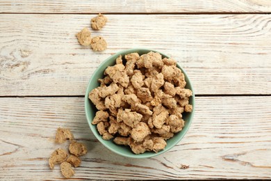 Photo of Dehydrated soy meat chunks on white wooden table, flat lay