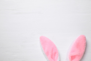 Decorative bunny ears and space for text on white wooden background, flat lay. Easter holiday