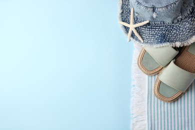 Photo of Flat lay composition with beach accessories on light blue background, space for text