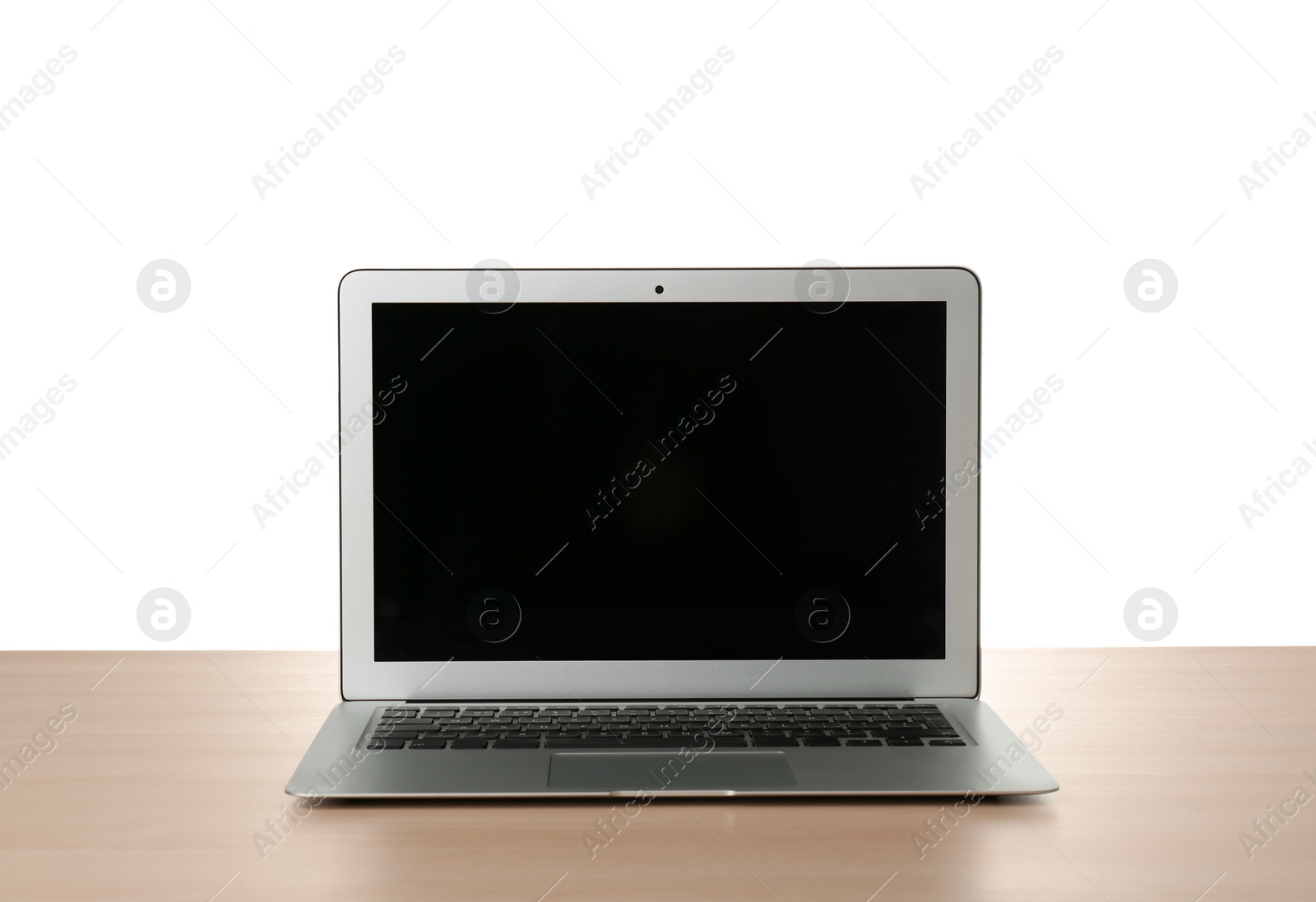Photo of Modern laptop with blank screen on table against white background