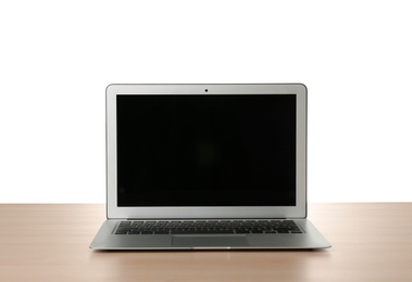 Modern laptop with blank screen on table against white background