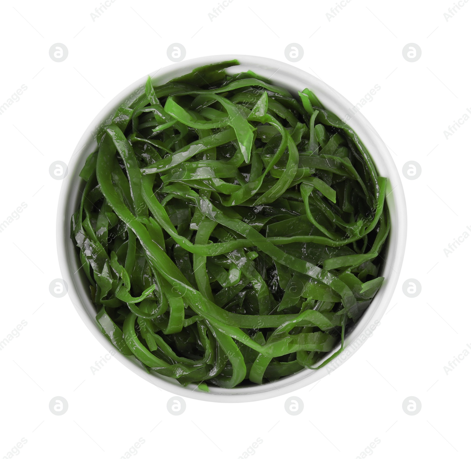 Photo of Tasty seaweed salad in bowl isolated on white, top view