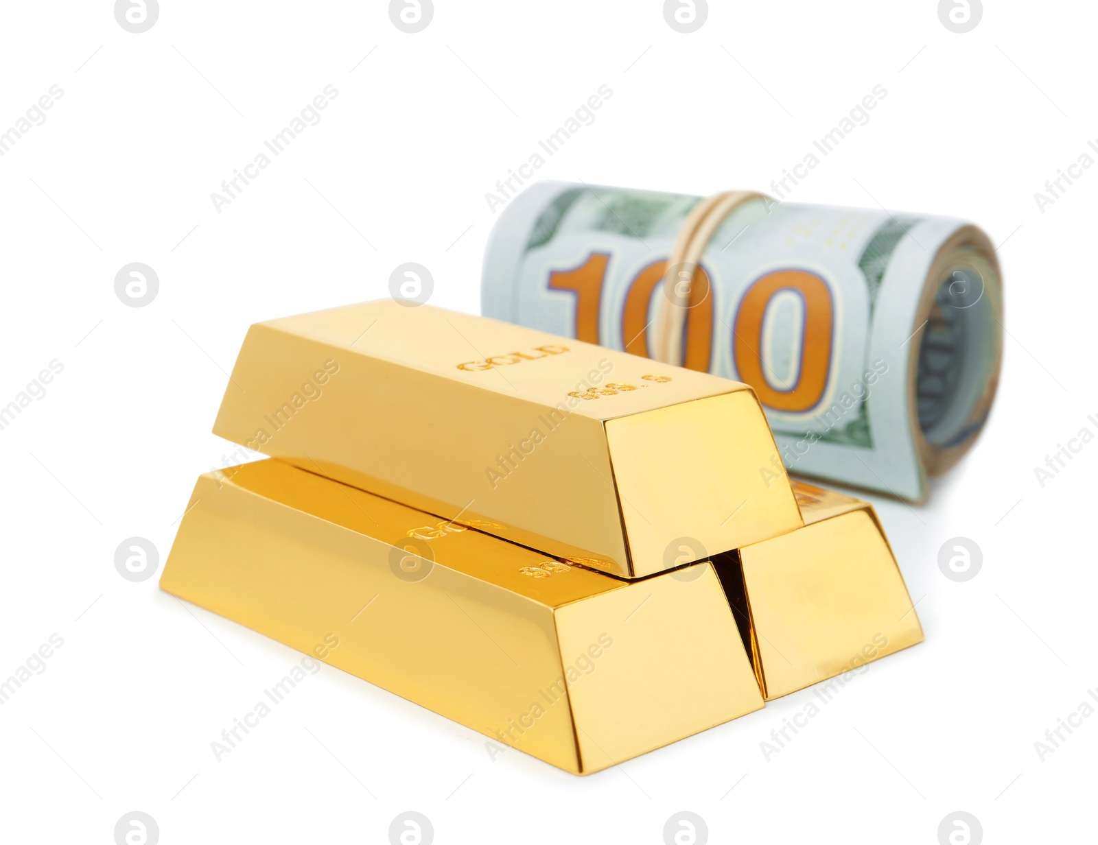 Photo of Shiny gold bars and dollar bills on white background