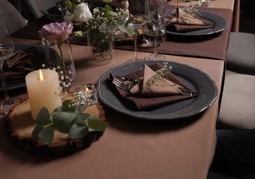 Elegant table setting with beautiful floral decor and burning candles