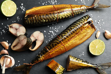 Flat lay composition with smoked fish on black table